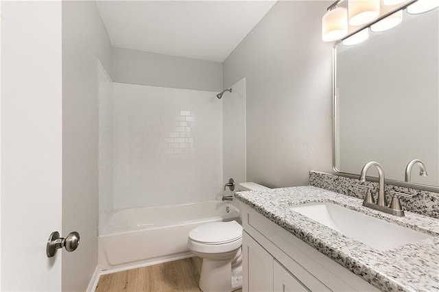 full bathroom with hardwood / wood-style floors, vanity, shower / bathtub combination, and toilet