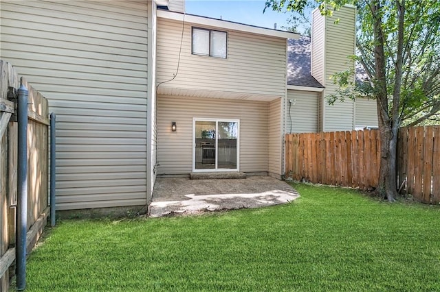 rear view of property with a patio and a lawn