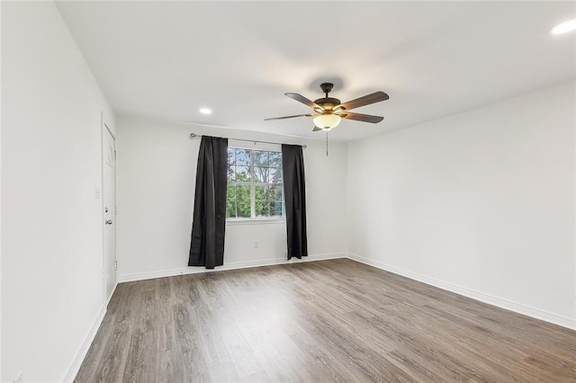 spare room featuring hardwood / wood-style floors and ceiling fan