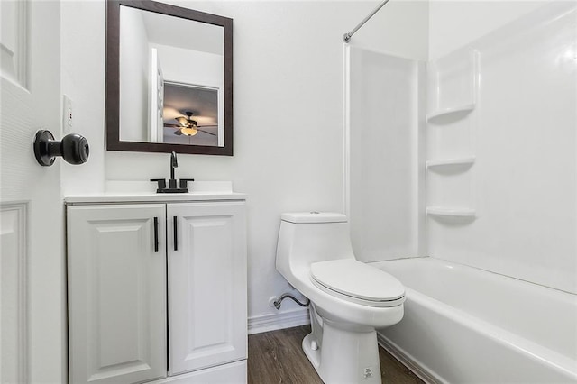 full bathroom with ceiling fan, bathing tub / shower combination, hardwood / wood-style floors, toilet, and vanity