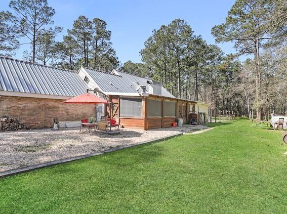 back of house with a lawn