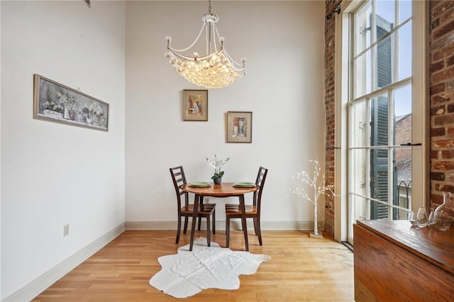 dining room featuring light hardwood / wood-style flooring and a notable chandelier