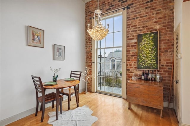 dining room featuring hardwood / wood-style flooring and an inviting chandelier