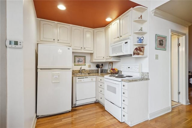 kitchen with white appliances, light hardwood / wood-style flooring, white cabinetry, and sink