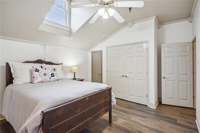 bedroom with a closet, hardwood / wood-style flooring, ceiling fan, and crown molding