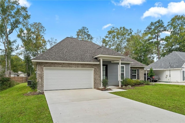 view of front of home with a front lawn, central AC unit, and a garage