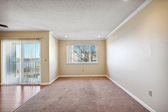 spare room with ceiling fan, crown molding, wood-type flooring, and a textured ceiling