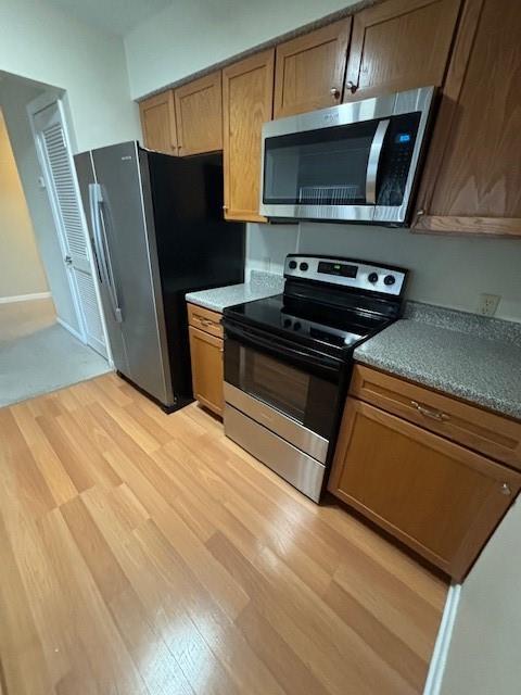 kitchen featuring appliances with stainless steel finishes and light wood-type flooring