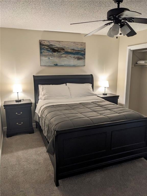 carpeted bedroom with ceiling fan and a textured ceiling