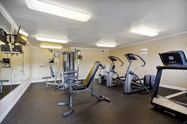 exercise room featuring crown molding