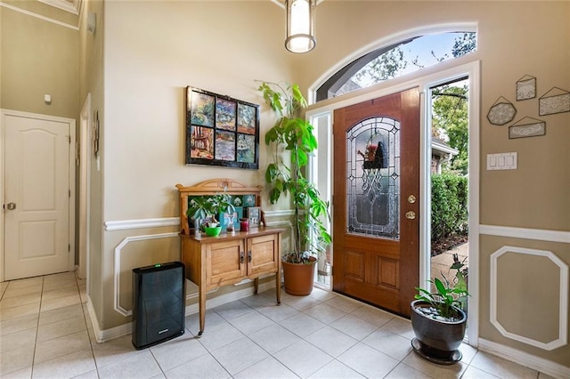 tiled foyer entrance featuring a high ceiling