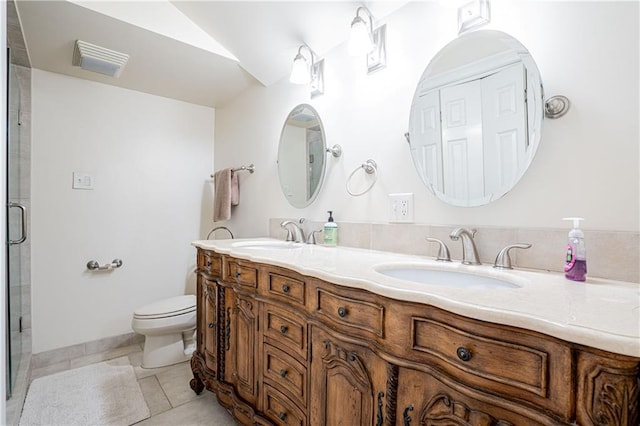 bathroom with toilet, vanity, tile patterned floors, and walk in shower