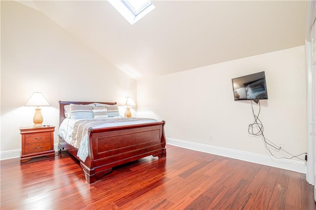 bedroom with wood-type flooring and lofted ceiling with skylight