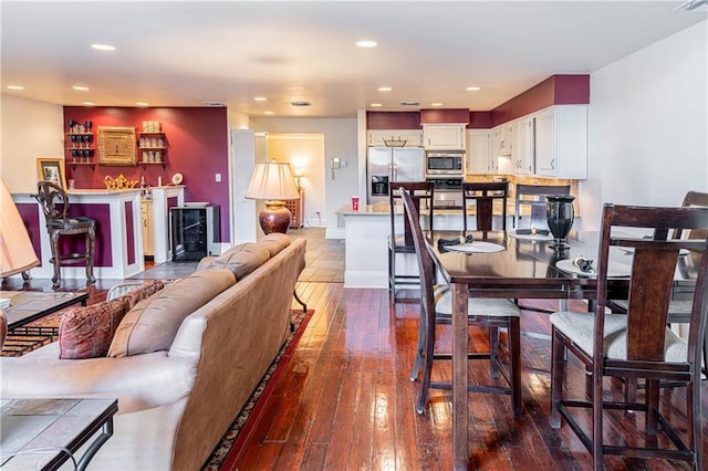 living room with wine cooler and wood-type flooring