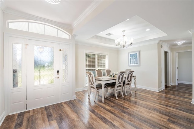 dining room featuring ornamental molding, a wealth of natural light, and dark wood-type flooring