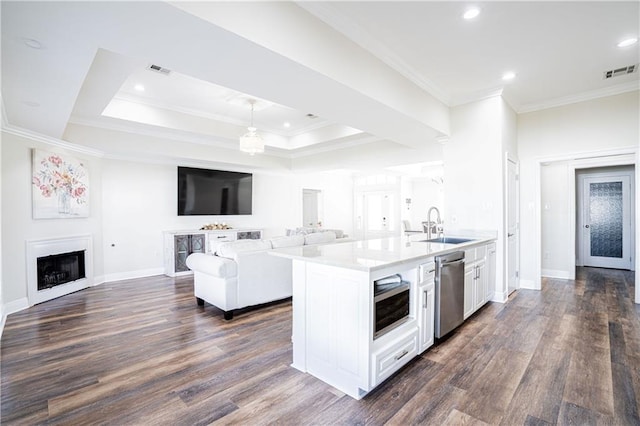 kitchen featuring a center island with sink, white cabinets, dark hardwood / wood-style floors, and appliances with stainless steel finishes