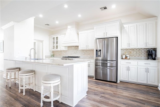 kitchen with white cabinetry, sink, stainless steel appliances, dark hardwood / wood-style floors, and backsplash