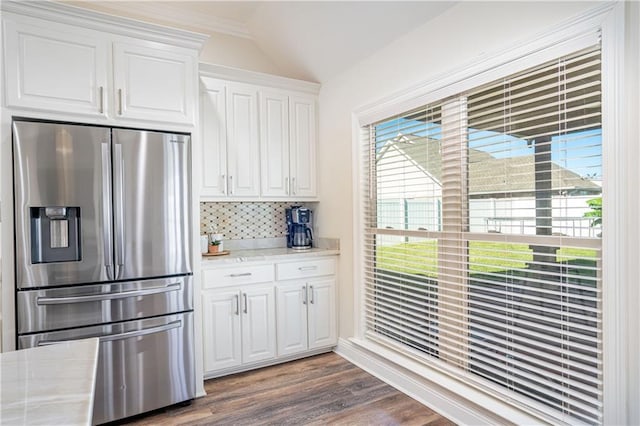 kitchen featuring lofted ceiling, backsplash, dark wood-type flooring, white cabinets, and stainless steel fridge with ice dispenser