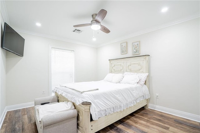 bedroom featuring ceiling fan, dark wood-type flooring, and ornamental molding