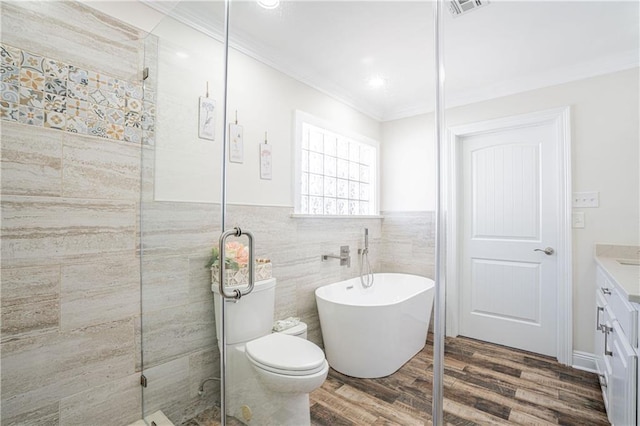 full bathroom with vanity, crown molding, hardwood / wood-style flooring, toilet, and tile walls