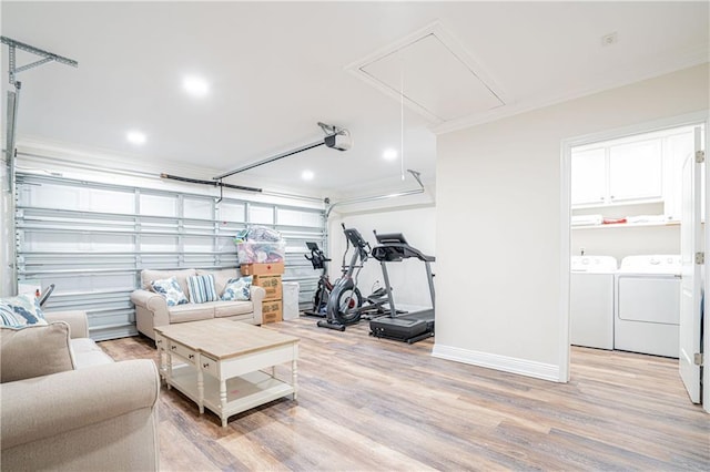 interior space featuring hardwood / wood-style flooring, crown molding, and washing machine and clothes dryer