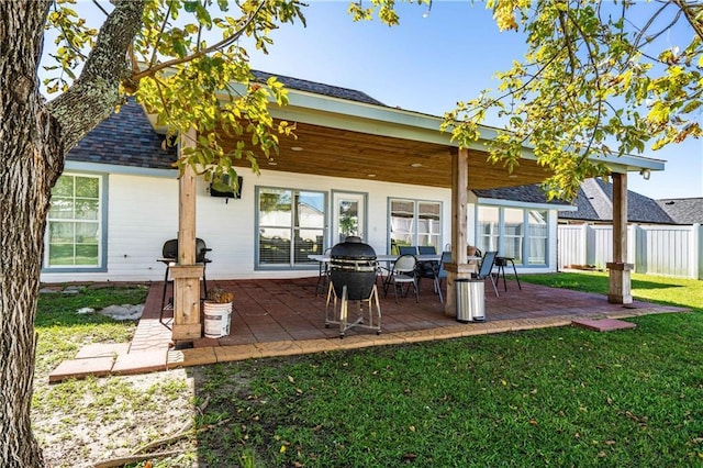 rear view of house featuring a patio area and a yard