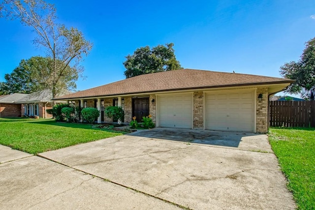 ranch-style home with a front yard and a garage