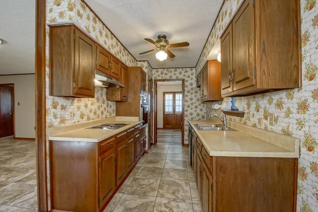 kitchen with stainless steel oven, a textured ceiling, ceiling fan, white stovetop, and sink