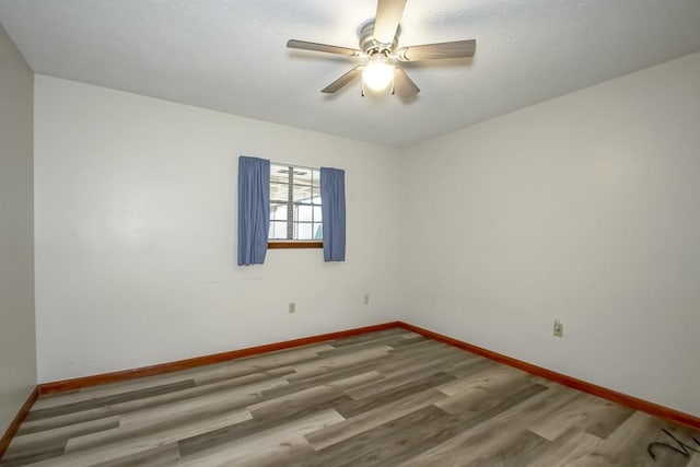 empty room featuring ceiling fan and hardwood / wood-style flooring