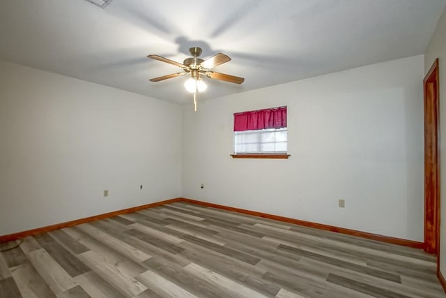 unfurnished room with wood-type flooring and ceiling fan