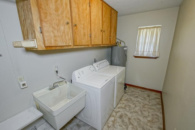 laundry area with cabinets, sink, separate washer and dryer, and water heater