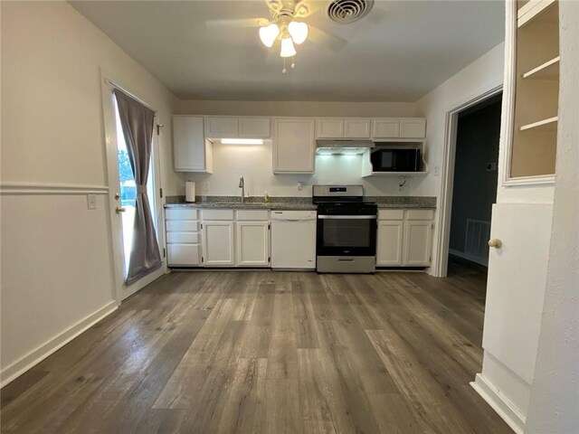 350 Carolyn Dr, Harahan, LA 70123 - kitchen with appliances with stainless steel finishes, a ceiling fan, under cabinet range hood, white cabinets, and dark wood-style flooring