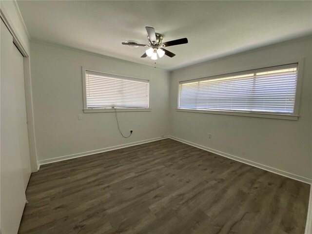 350 Carolyn Dr, Harahan, LA 70123 - unfurnished bedroom featuring a closet, dark wood-style flooring, and a ceiling fan