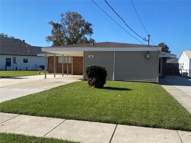 350 Carolyn Dr, Harahan, LA 70123 - ranch-style house featuring a front yard, brick siding, concrete driveway, and a carport