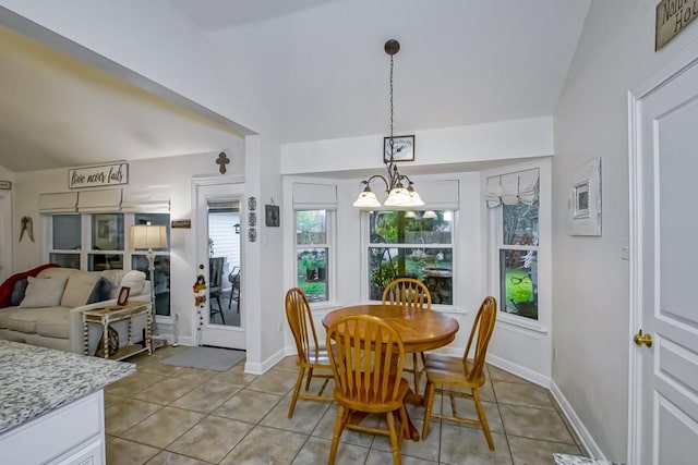 dining room with vaulted ceiling, an inviting chandelier, and light tile patterned flooring