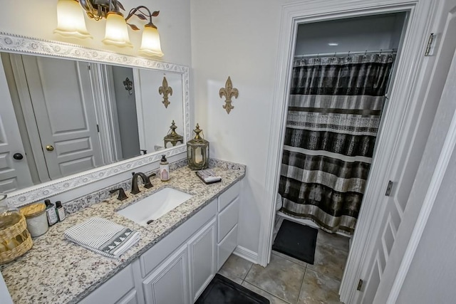 bathroom with tile patterned flooring, a shower with curtain, and vanity