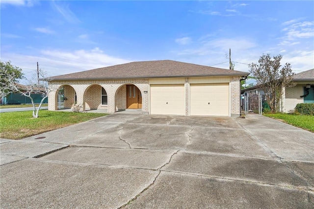 single story home with a garage and a front lawn