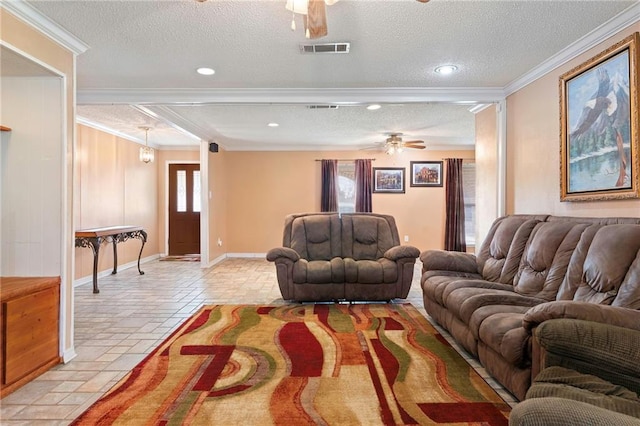 living room featuring ceiling fan, ornamental molding, and a textured ceiling