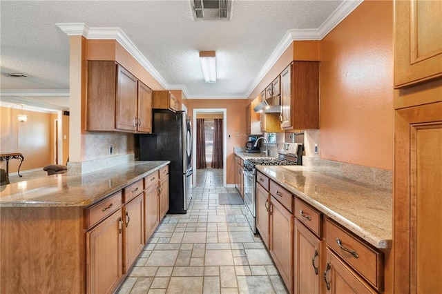 kitchen featuring crown molding, light stone countertops, a textured ceiling, and appliances with stainless steel finishes