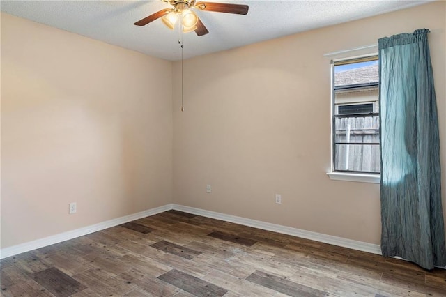 empty room featuring ceiling fan, wood-type flooring, and a textured ceiling