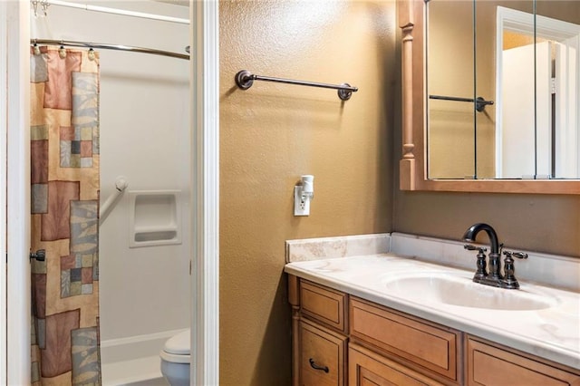 bathroom featuring a shower with curtain, vanity, and toilet