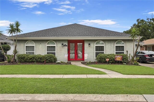 ranch-style house featuring french doors and a front yard