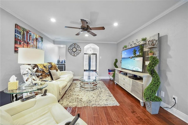 living room with ceiling fan, dark hardwood / wood-style flooring, and ornamental molding