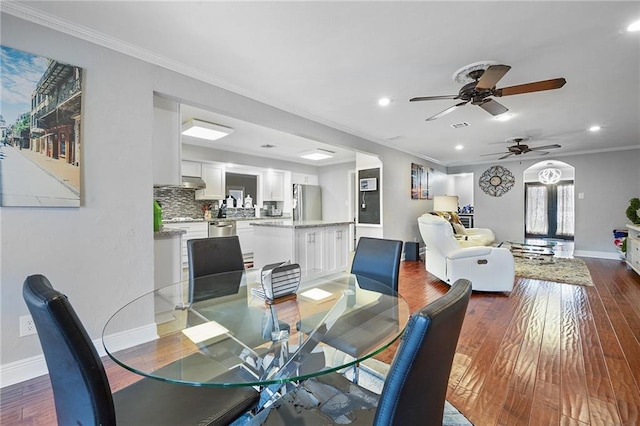 dining area with ceiling fan, dark hardwood / wood-style flooring, french doors, and ornamental molding