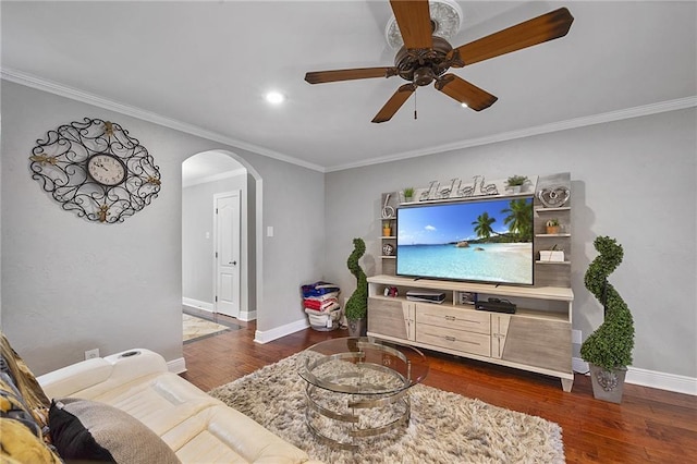 living room with ceiling fan, dark hardwood / wood-style flooring, and crown molding