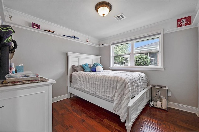 bedroom with dark wood-type flooring and ornamental molding