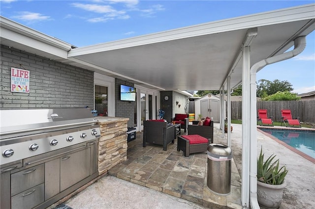 view of patio featuring an outdoor living space, a fenced in pool, and a storage shed