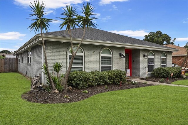 ranch-style house with a front lawn