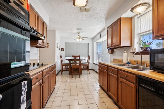 20 Cocodrie Ct, Kenner, LA 70065 - kitchen featuring ceiling fan, a sink, light countertops, under cabinet range hood, and black appliances