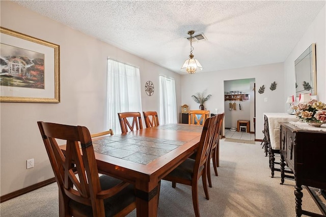 20 Cocodrie Ct, Kenner, LA 70065 - dining area featuring visible vents, a textured ceiling, baseboards, and light carpet